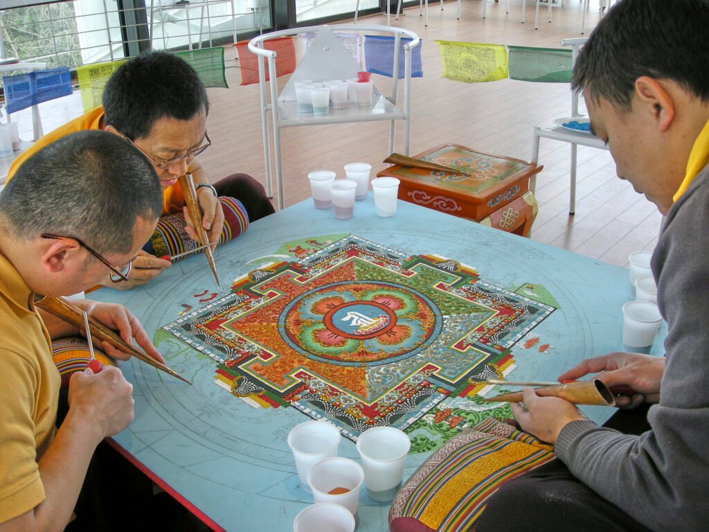 Monks making a detailed Tibetan sand mandala